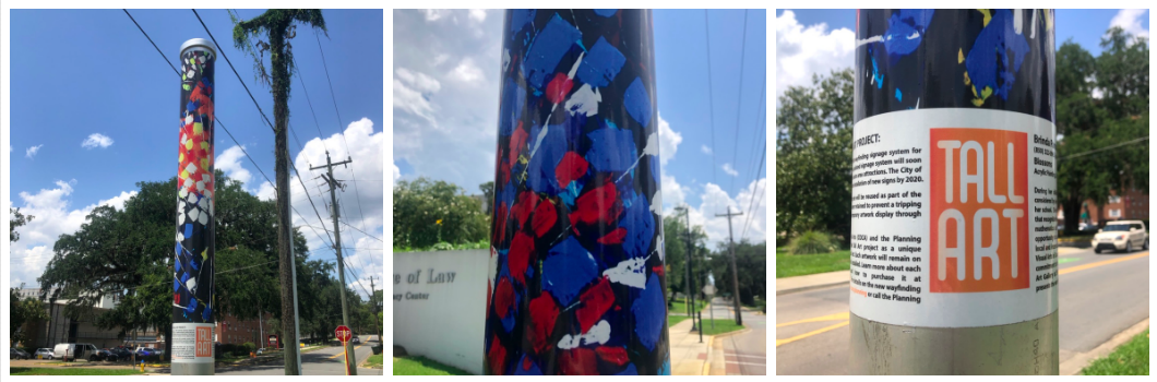 Vinyl wrapped wayfinding poll that depicts Brinda Pamulapati's installation of the acrylic painting "Blossoms" (2016). Red, blues, whits and yellows make up the abstract bouquet. 