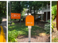 COCA's Inspiration Exchange mailbox is orange and bold. Inside you can take or leave art supplies to inspire others.