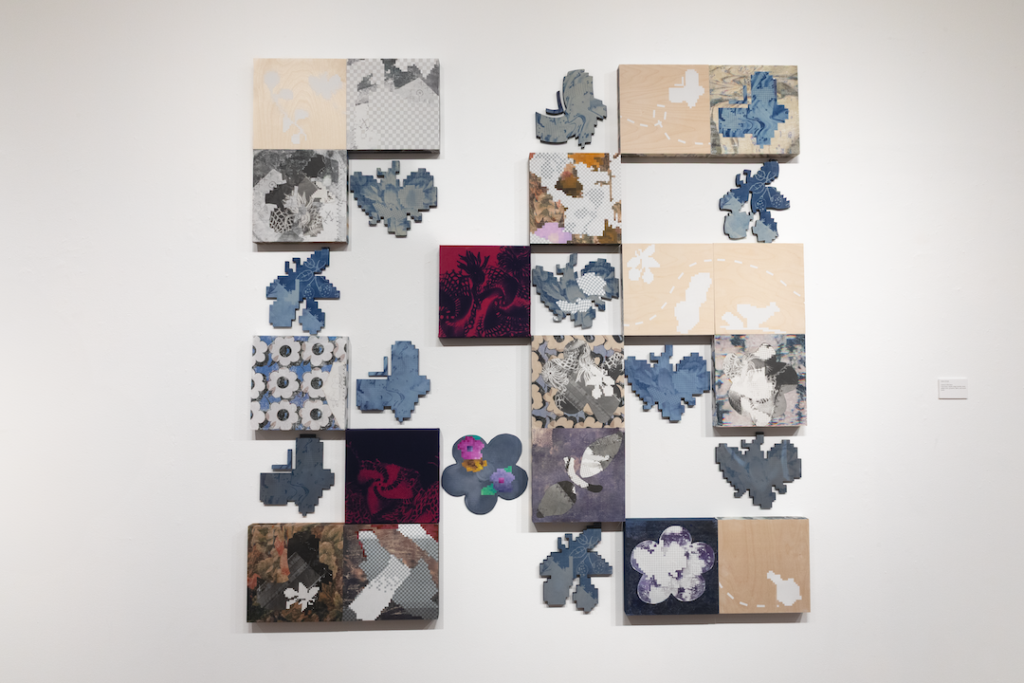 several pieces of art are displayed on a wall in a museum